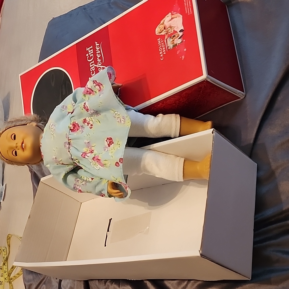 2 American Girl  dolls plus 1 doll on roller skates